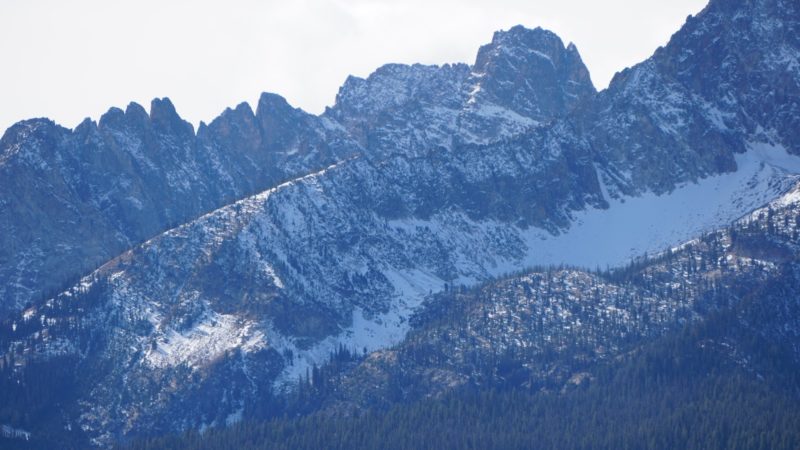 Early season snow cover on Williams Peak in the Sawtooth Mtns, with Thompson Peak in the background. 